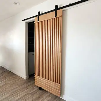 Solid wood board and batten sliding barn door for closet